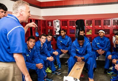 Basketball coach and team in locker room