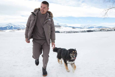 man walking dog in snow