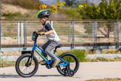 Boy learning how to ride a bike with Star Wars bike helmet on