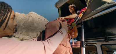 A person carries a duffle bag to their car