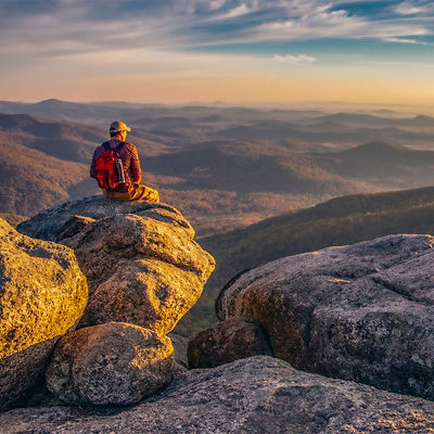 A hiker enjoying the view on Old Rag Mountain in Shenandoah Wilderness at Sunrise