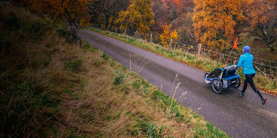 Mom and child enjoying a run together. Cairngorms National Park, Scotland.