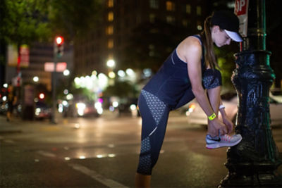 Picture of a woman preparing to run at night.