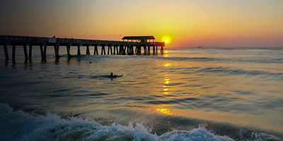 Ocean sunset and sufer on Tybee Island 