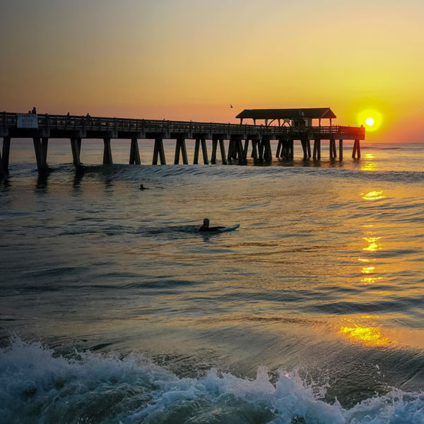Ocean sunset and sufer on Tybee Island 