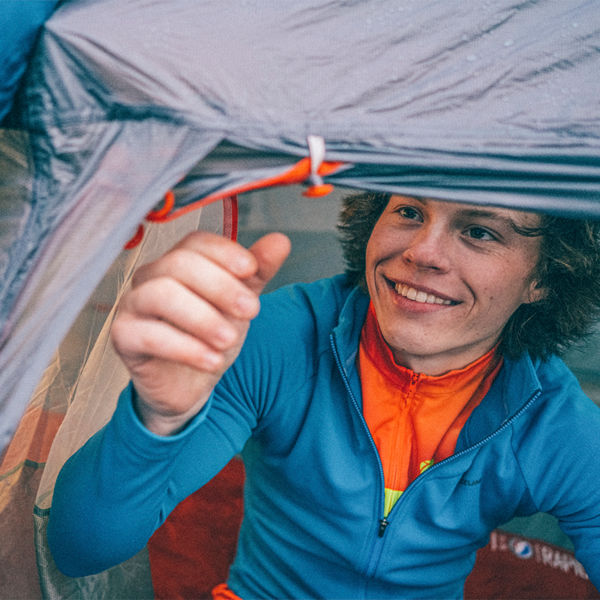 A man looks to close his tent