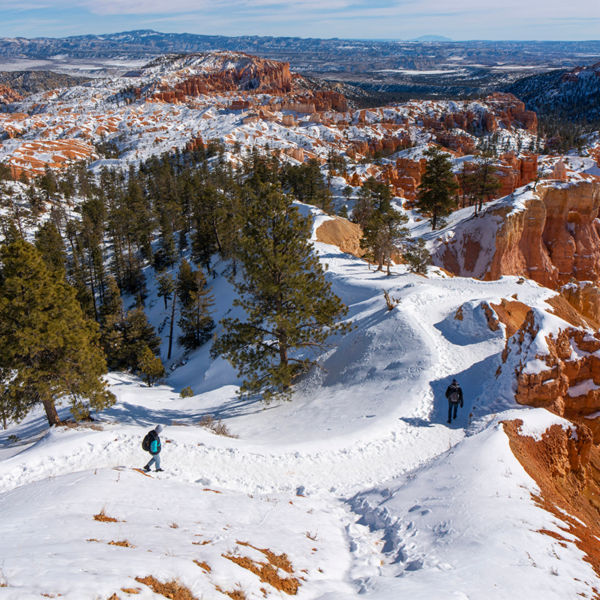 People walk on the trail in the snow at Bryce Canyon National Park