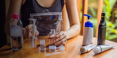 A person packs a toiletry bag