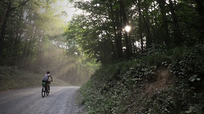 A woman rides a bike on the bull and jake trail in N Georgia  