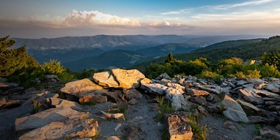 A dramatic sunset viewed from Spruce Knob West Virginia in the Appalachian Mountains looking down on hills in the surrounding valleys