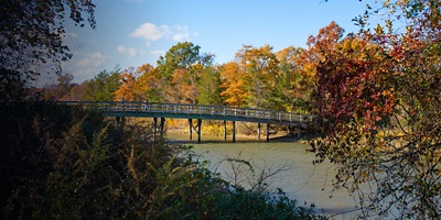 A pedestrian bridge crosses a stream at Sunken Meadow State Park in New York.