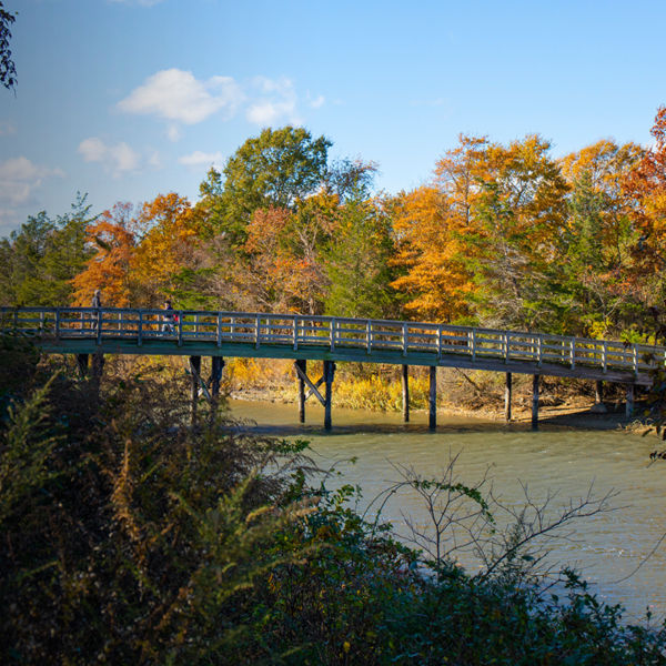 A pedestrian bridge crosses a stream at Sunken Meadow State Park in New York.