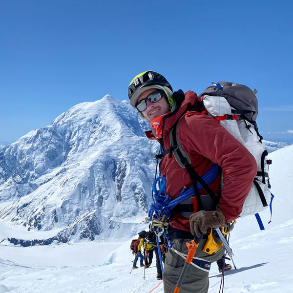 Josh Jespersen poses for the camera out in the snowy mountains 