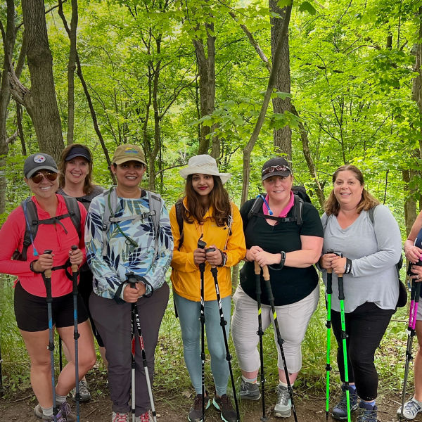 Women pose for a group photo while hiking