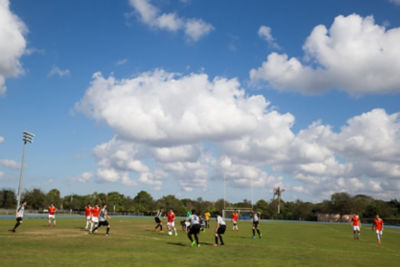Two teams playing soccer on a field