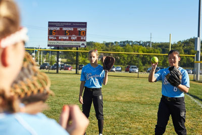 Image of teen girls playing softball catch