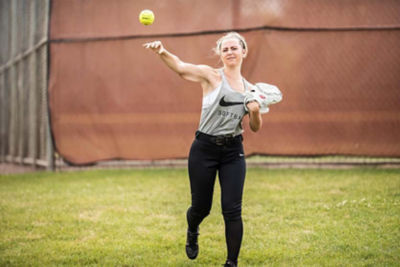 softball player through a ball