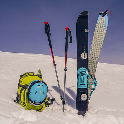 Splitboard halves, trekking sticks and backpack