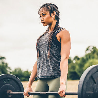 A woman lifts weights in a deadlift
