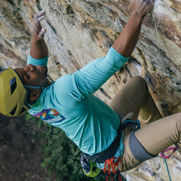 Climber on a rock wall wearing helmet