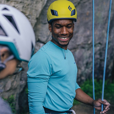 Two Climbers prepping to climb wearing helmets