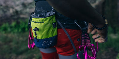 Climber wearing harness with chalk bag and gear on it