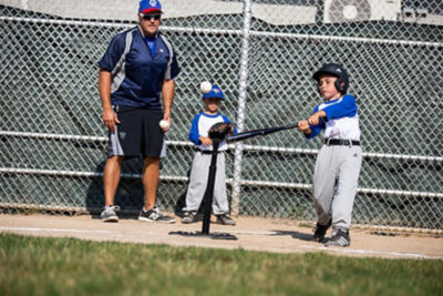 Kids and coach playing Tee ball