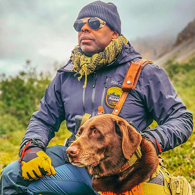Chad Brown looks on at Arctic National Wildlife Refuge with his dog