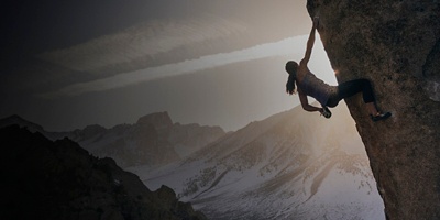 Climber chalks up on Saigon Direct, a classic boulder problem in the Buttermilks near Bishop, California.