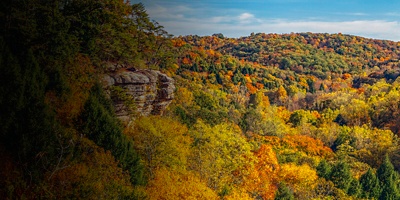The southwestern Ohio autumn landscape is painted with the colors of fall leaves as viewed high above the trees and rock walls of Conkle’s Hollow in the beautiful Hocking Hills.