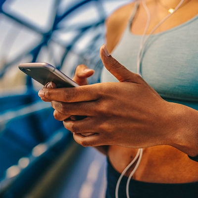 A person checks their phone when running
