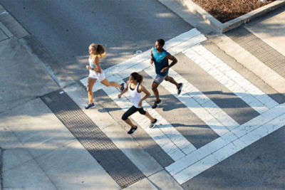 Picture of runners crossing a street together.