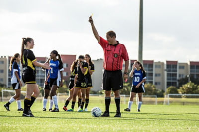 Soccer referee holding a yellow card