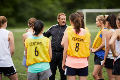 Girls soccer team listening to a coach