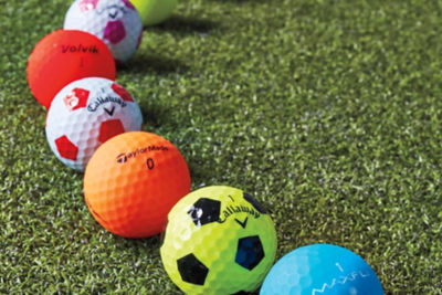 colorful golf balls laying on the grass
