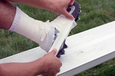 Player taping football cleat