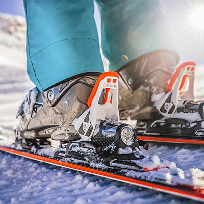 Winter skis and detailed view of the ski boots on sunny day.
