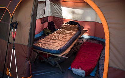 Tent with open door and camping equipment inside