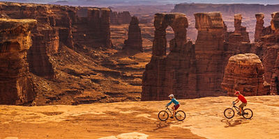 Male and female cyclist riding bikes at White Rim Trail in Canyonlands National Park