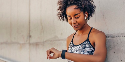 A woman looks down at her watch.