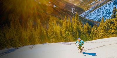 A woman snowshoeing in the mountains