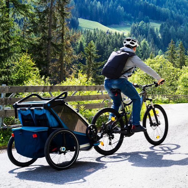 Family With E Bike MTB And Kid Trailer Training