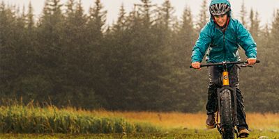 Woman biking in the rain