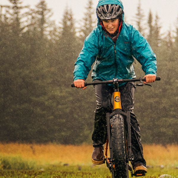 Woman biking in the rain