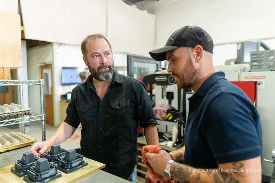 Troy and PMD employee looking at 3D printed parts with Multi Jet Fusion