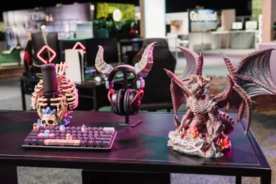 HyperX 3D-printed, personalized gaming accessories (left to right): Quadcast Microphone with a fantasy microphone holder, Alloy Origins keyboard with 3D keycaps, Cloud Alpha Wireless headset with rams horns accessory, 3D-printed dragon character.   