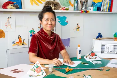 Lorraine Nam at her desk filming a YouTube tutorial for craft store Michael's.