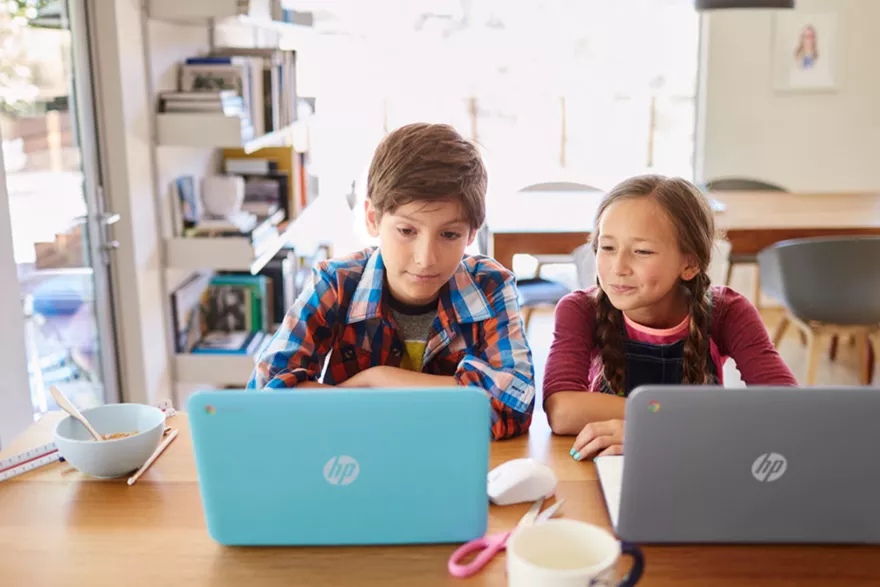 Students at an HP laptop computer writing future self letters. 