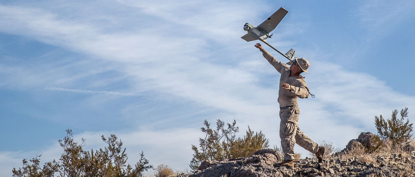 RQ-11 Raven small unmanned aerial vehicle being launched by a Marine for surveillance. 
