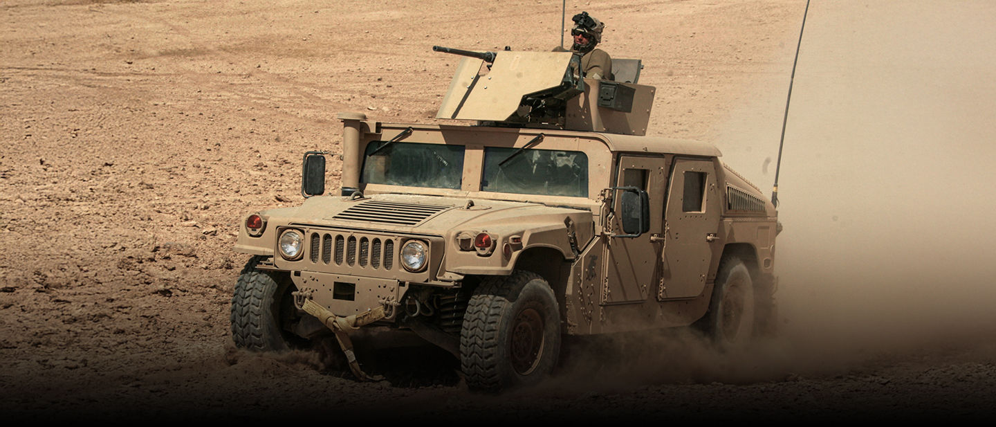 Marines drive a JLTV and man its machine gun during combat operations in Iraq.